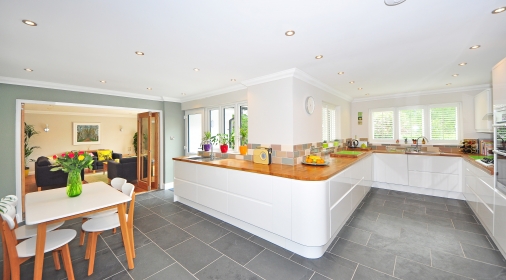 clean kitchen with grey tile floor and kitchen table