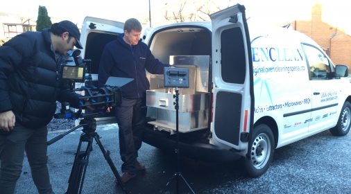 an ovenclean van with doors open and people taking pictures of what is inside