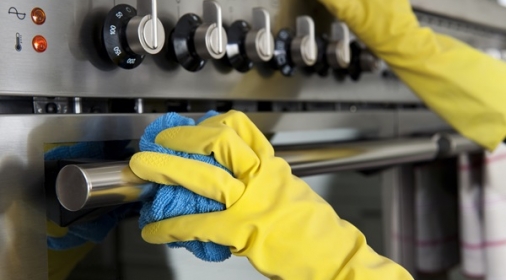 Someone cleaning an oven